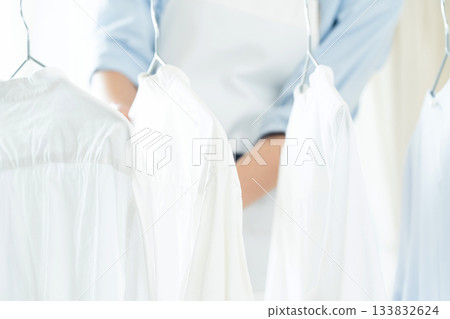 Young lady hanging laundry 133832624
