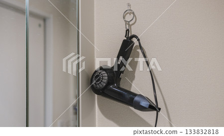 Interior view of a hair dryer hanging in the bathroom Interior view of a hair dryer hanging in the bathroom 133832818