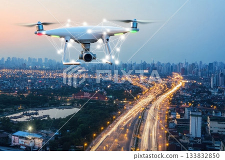 A drone is flying over a city at night, capturing the lights A drone is flying over a city at night, capturing the lights 133832850