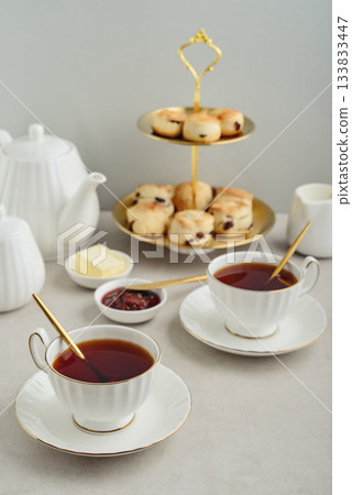 English Afternoon Tea in elegant white porcelain cups English Afternoon Tea in elegant white porcelain cups 133833447