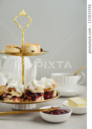 Golden two-tiered stand with homemade scones Golden two-tiered stand with homemade scones 133833456