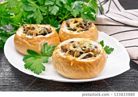 Buns stuffed with mushrooms in plate on black board 133833980