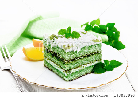 Cake with orange and mint in plate on board Cake with orange and mint in plate on board 133833986