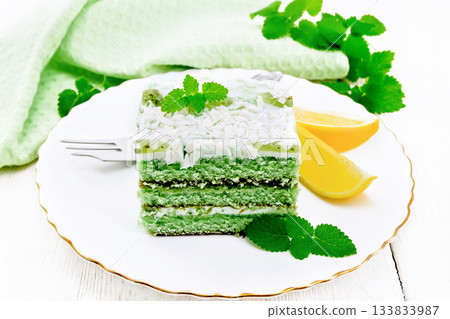 Cake with orange and mint in plate on wooden board Cake with orange and mint in plate on wooden board 133833987