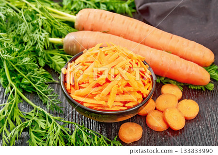 Carrots grated in bowl on black board Carrots grated in bowl on black board 133833990
