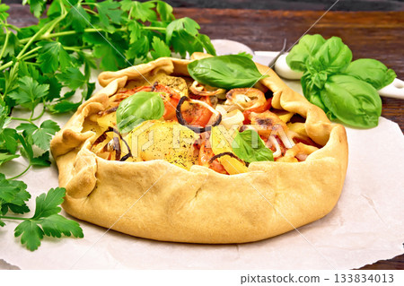 Galette of potato and tomato on board 133834013