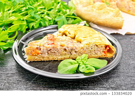 Galette with minced meat and peppers in plate on dark board 133834020