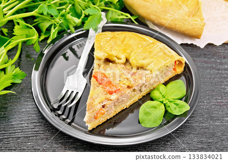 Galette with minced meat and peppers in plate on wooden board 133834021