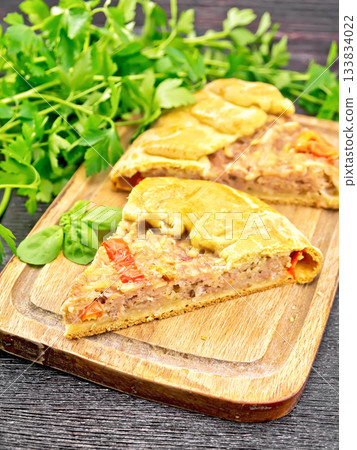 Galette with minced meat and peppers on black board Galette with minced meat and peppers on black board 133834022
