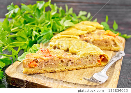 Galette with minced meat and peppers on wooden board 133834023