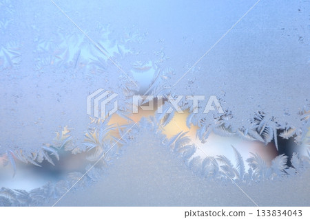 Winter frost patterns on glass Winter frost patterns on glass 133834043