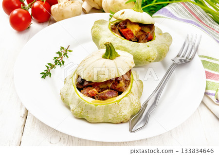 Patissons stuffed with liver in plate on board 133834646