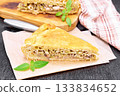Pie with meat and cabbage on paper 133834652