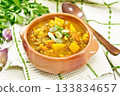 Soup-curry with pumpkin and lentils in bowl on towel 133834657