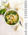 Soup with meatballs and pasta in bowl on granite table top 133834660