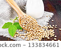 Soybeans in spoon with milk on board 133834661