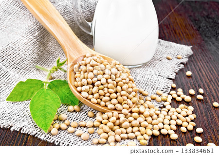 Soybeans in spoon with milk on board 133834661