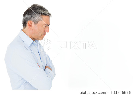 Senior man wearing light blue dress shirt folding arms and gazing right in studio, copy space Senior man wearing light blue dress shirt folding arms and gazing right in studio, copy space 133836636