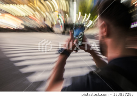Man Photographing City Crosswalk at Night 133837293