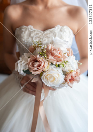Close-up of an elegant wedding bouquet held by a bride Close-up of an elegant wedding bouquet held by a bride 133837551