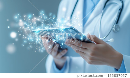 Doctor wearing lab coat and stethoscope using tablet with futuristic network interface performing medical treatment represents innovation in healthcare 133837957