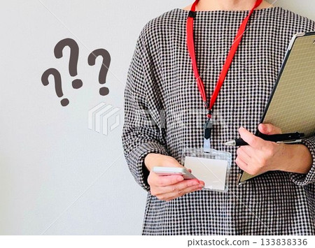 一位上班的女士正在用智慧型手機查看一些她看不懂的東西。 一位上班的女士正在用智慧型手機查看一些她看不懂的東西。 133838336
