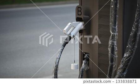 Electric vehicle charging station in a quiet area Electric vehicle charging station in a quiet area 133838871