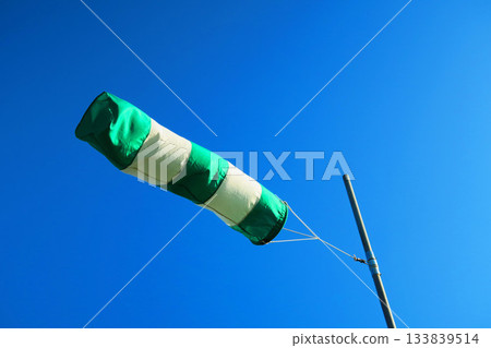 A scene of windsocks fluttering in the wind and blue sky 133839514