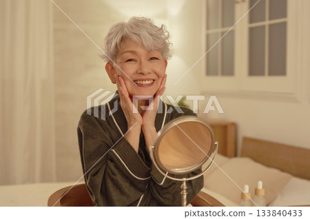Senior woman's nighttime facial care 133840433