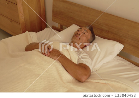 Senior man sleeping in bedroom 133840458