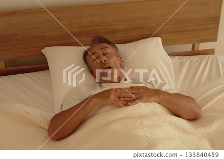 Senior man sleeping in bedroom Senior man sleeping in bedroom 133840459