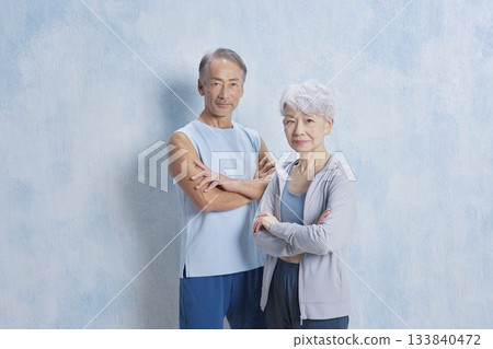 Portrait of senior man and woman exercising, looking at camera 133840472