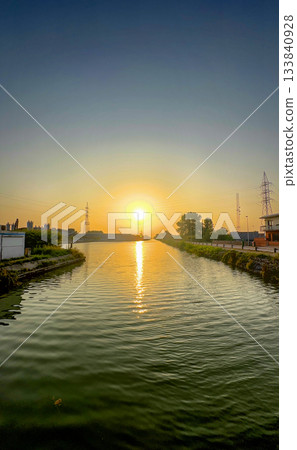 Serene sunset highlighting city life and peaceful waterscape Serene sunset highlighting city life and peaceful waterscape 133840928