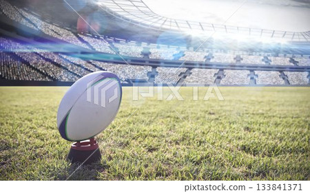 3D render showing rugby ball sitting upright on kicking tee inside stadium with floodlights shining 3D render showing rugby ball sitting upright on kicking tee inside stadium with floodlights shining 133841371