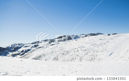 Snowy mountain under blue sky Snowy mountain under blue sky 133841501
