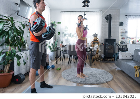 Joint Strength training of husband and wife at home with dumbbells Joint Strength training of husband and wife at home with dumbbells 133842023