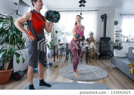 Joint Strength training of husband and wife at home with dumbbells Joint Strength training of husband and wife at home with dumbbells 133842025