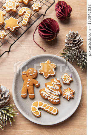 Christmas gingerbread cookies decorating with white icing for holidays 133842038