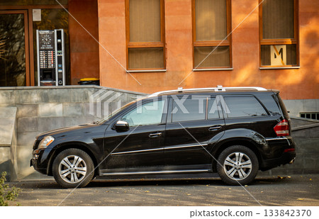 Yerevan Armenia 11.25.2025. A black Mercedes parked in front of a building Yerevan Armenia 11.25.2025. A black Mercedes parked in front of a building 133842370