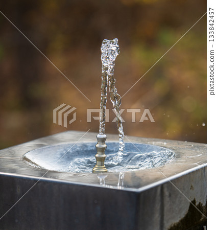 A fountain with water shooting out of it A fountain with water shooting out of it 133842457