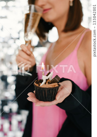 Chocolate Cupcake With Burning Candle In Hand Chocolate Cupcake With Burning Candle In Hand 133842801