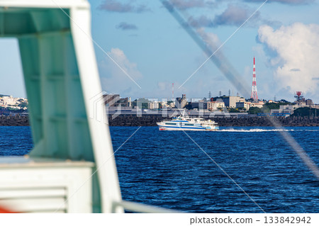 A high-speed jet ferry bound for Tokashiki Island in the Kerama Islands. Marine Liner Tokashiki. Boarding Queen Zamami No. 3. 133842942
