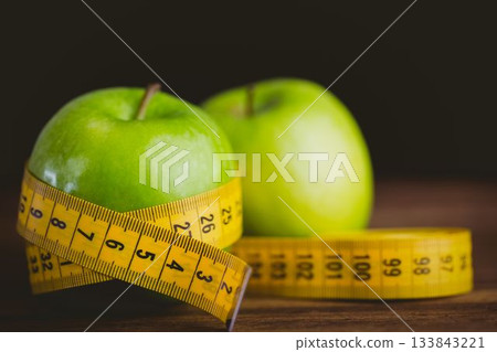Green apples and measuring tape 133843221