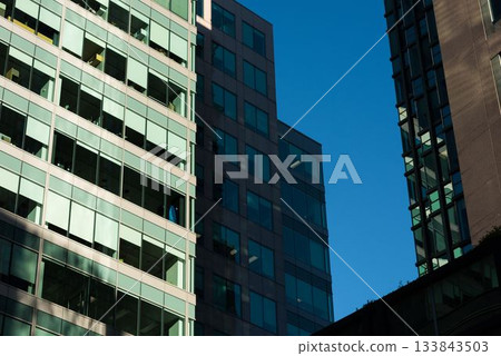 ow angle view of modern glass buildings against sky ow angle view of modern glass buildings against sky 133843503
