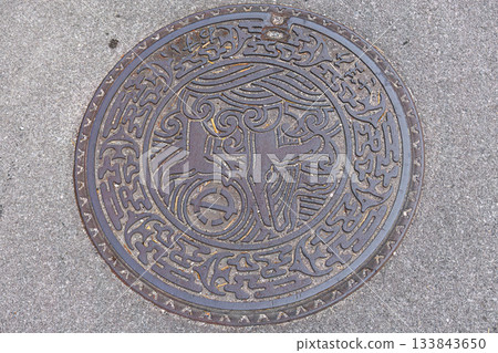 來自座間味島的精美井蓋。井蓋上繪有一隻座頭鯨,這種鯨魚則生活在附近的海域。沖繩縣島尻郡慶良間町座間味島港 來自座間味島的精美井蓋。井蓋上繪有一隻座頭鯨,這種鯨魚則生活在附近的海域。沖繩縣島尻郡慶良間町座間味島港 133843650