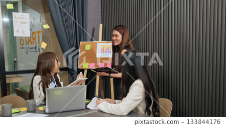 Business women meet, busy team people discuss project work, professional colleagues collaborate during meeting, analyzing charts, graphs for successful business development, planning future strategy. Business women meet, busy team people discuss project work, professional colleagues collaborate during meeting, analyzing charts, graphs for successful business development, planning future strategy. 133844176
