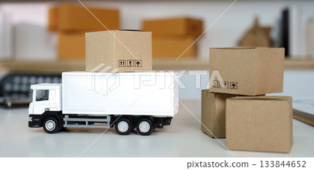 Logistics Concept. A toy truck with cardboard boxes representing delivery services. 133844652
