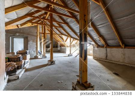 Large Unfinished Attic with Wooden Supports and Storage Boxes Large Unfinished Attic with Wooden Supports and Storage Boxes 133844838