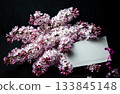 Lilac Blossoms Set Against Dark Planks with a Blank Gift Tag 133845148