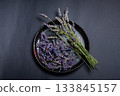 Lavender Flowers on Plate with Crushed Lavender Petals Displayed 133845157